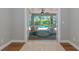 Enclosed patio with comfortable seating and a view of the sparkling swimming pool and lush greenery outside at 6964 Glacier Ave, North Port, FL 34291