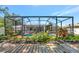 An inviting screened-in pool area complemented by lush landscaping for privacy and relaxation at 6964 Glacier Ave, North Port, FL 34291