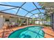 A stunning screened-in pool area with a table and chairs perfect for outdoor dining at 6964 Glacier Ave, North Port, FL 34291