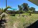 Spacious backyard with a shade covering and a firepit perfect for outdoor entertaining at 700 Forest St, Nokomis, FL 34275