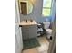 Bathroom featuring a modern vanity with a round mirror, toilet, and neutral wall color at 700 Forest St, Nokomis, FL 34275