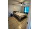 Cozy bedroom with a ceiling fan, bright windows, and a comfortable bed for restful nights at 700 Forest St, Nokomis, FL 34275