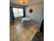 Inviting dining area with a round wooden table, chairs, and natural light at 700 Forest St, Nokomis, FL 34275