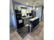 Kitchen with modern appliances, a stylish island, updated cabinets, and recessed lighting at 700 Forest St, Nokomis, FL 34275