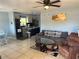 Comfortable living room with tile floors, a ceiling fan, and a sofa with recliners at 700 Forest St, Nokomis, FL 34275