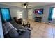 Cozy living room with tile flooring, comfortable seating, and entertainment center at 700 Forest St, Nokomis, FL 34275