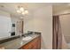 Bathroom with wood cabinets and shower with curtains at 700 Gardens Edge Dr # 722, Venice, FL 34285