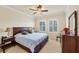This bedroom offers a ceiling fan, two windows and a queen bed at 700 Gardens Edge Dr # 722, Venice, FL 34285