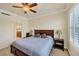 This bedroom offers a ceiling fan and a queen bed at 700 Gardens Edge Dr # 722, Venice, FL 34285