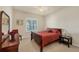Bedroom features a queen bed, window with shutters and furniture at 700 Gardens Edge Dr # 722, Venice, FL 34285