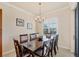 Elegant dining room with a large table, chandelier, and natural light streaming in at 700 Gardens Edge Dr # 722, Venice, FL 34285