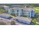 Aerial view of the building with well-maintained grounds and assigned parking spaces at 700 Gardens Edge Dr # 722, Venice, FL 34285
