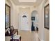 Inviting foyer with tile flooring and arched doorways, leading into the home at 700 Gardens Edge Dr # 722, Venice, FL 34285