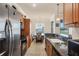 Traditional kitchen featuring wood cabinets, granite countertops, and stainless steel appliances at 700 Gardens Edge Dr # 722, Venice, FL 34285