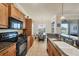 Well-equipped kitchen flowing into a dining room with bar top and modern appliances at 700 Gardens Edge Dr # 722, Venice, FL 34285