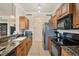 Galley kitchen features granite countertops, tile floors, and stainless appliances at 700 Gardens Edge Dr # 722, Venice, FL 34285