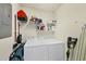 Well-organized laundry room with washer, dryer, and shelving for storage at 700 Gardens Edge Dr # 722, Venice, FL 34285