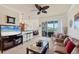 Cozy living room featuring a comfortable seating arrangement and access to the outdoors at 700 Gardens Edge Dr # 722, Venice, FL 34285