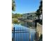 Scenic view of a well-maintained apartment complex overlooking a pond with palm trees at 700 Gardens Edge Dr # 722, Venice, FL 34285