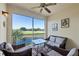 Relaxing screened porch with wicker furniture and view of a serene lake and golf course at 700 Gardens Edge Dr # 722, Venice, FL 34285