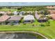 Aerial view of homes, golf course, and pond at The Plantation community, Venice, Florida at 809 Derbyshire Dr, Venice, FL 34285