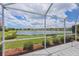 The backyard and enclosed patio overlook a beautiful lake at 809 Derbyshire Dr, Venice, FL 34285