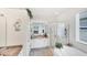 Bright bathroom boasts granite counters, glass shower and relaxing tub with a view at 809 Derbyshire Dr, Venice, FL 34285
