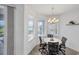 Bright breakfast nook with a chandelier and views of the lake, perfect for casual dining and enjoying the scenery at 809 Derbyshire Dr, Venice, FL 34285