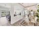 Bright dining space with a chandelier and views of the water, seamlessly connecting to the living area at 809 Derbyshire Dr, Venice, FL 34285