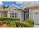 Close up of home with meticulously maintained landscaping, an attractive front entrance, and a visible security system at 809 Derbyshire Dr, Venice, FL 34285