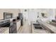 Spacious kitchen with granite countertops, stainless appliances, and access to the living room in Venice, Florida at 809 Derbyshire Dr, Venice, FL 34285