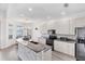 Bright kitchen featuring white cabinetry, stainless steel appliances, and a cozy breakfast nook with views of the lake at 809 Derbyshire Dr, Venice, FL 34285