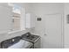 Bright laundry room featuring Samsung washer and dryer, white cabinets, and a window for natural light at 809 Derbyshire Dr, Venice, FL 34285