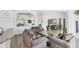 Bright living room featuring an open layout, neutral décor, and an elegant display case in The Plantation community, Venice, Florida at 809 Derbyshire Dr, Venice, FL 34285