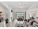 Bright living room boasts modern decor, hardwood floors, and sliding glass doors with lake view at 809 Derbyshire Dr, Venice, FL 34285