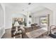 Bright living room boasts modern decor, hardwood floors, and sliding glass doors to patio at 809 Derbyshire Dr, Venice, FL 34285