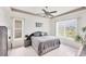 Spacious primary bedroom with tile floor and ceiling fan, providing a cozy and relaxing retreat at 809 Derbyshire Dr, Venice, FL 34285