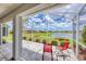 Enclosed patio boasts scenic lake views, seating and beautiful landscape at 809 Derbyshire Dr, Venice, FL 34285