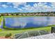 Scenic view of a tranquil lake reflecting the sky, surrounded by homes in The Plantation community, Venice, Florida at 809 Derbyshire Dr, Venice, FL 34285