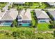 Aerial view of homes with screened in pools and landscaping at 8245 Grande Shores Dr, Sarasota, FL 34240