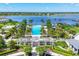Aerial view of a luxurious pool and recreation area with lake view, nestled in a beautiful community at 8245 Grande Shores Dr, Sarasota, FL 34240