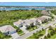 Beautiful aerial view of the home showcasing the lush landscaping and proximity to the serene lake at 8245 Grande Shores Dr, Sarasota, FL 34240