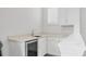 Bright bar area with quartz counters, wine fridge, and white cabinets at 8245 Grande Shores Dr, Sarasota, FL 34240