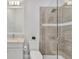 Bathroom featuring a glass shower, a tiled wall, and a white vanity at 8245 Grande Shores Dr, Sarasota, FL 34240