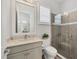 Bathroom featuring a glass shower, a tiled wall, and a white vanity with stone counter at 8245 Grande Shores Dr, Sarasota, FL 34240