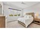 This bedroom offers a large window with peaceful green outdoor views and neutral decor at 8245 Grande Shores Dr, Sarasota, FL 34240