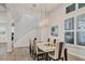 Dining room featuring modern lighting fixture, staircase, and large windows allowing natural light at 8245 Grande Shores Dr, Sarasota, FL 34240