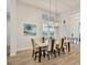 Elegant dining room with modern chandelier and large windows offering abundant natural light at 8245 Grande Shores Dr, Sarasota, FL 34240