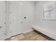 A bright entry includes a built-in bench, wood look flooring, and a convenient door at 8245 Grande Shores Dr, Sarasota, FL 34240