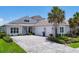 Charming home with a three-car garage, well-manicured landscaping, and a lovely paver driveway at 8245 Grande Shores Dr, Sarasota, FL 34240